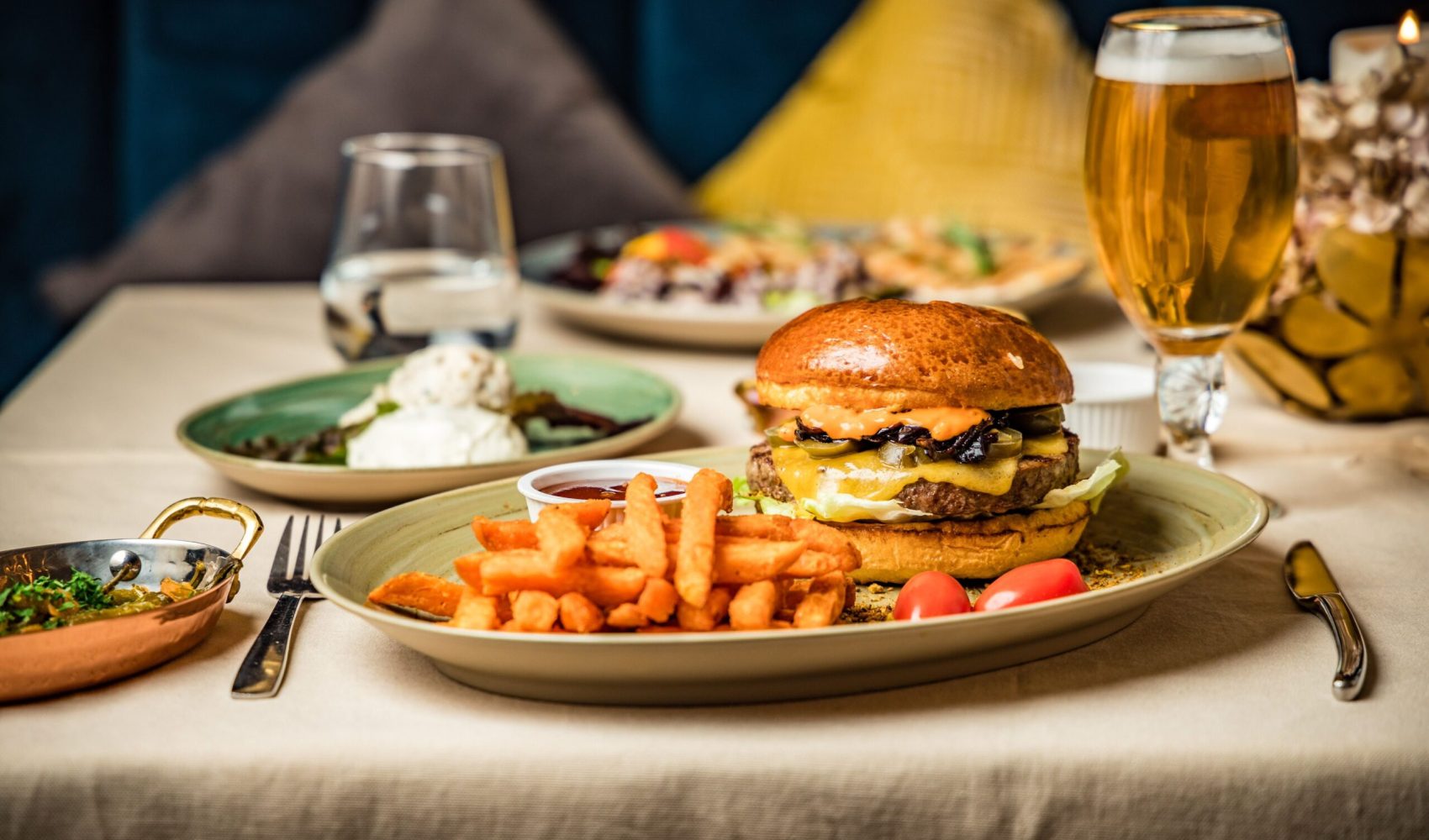 A closeup of burger with French fries on table